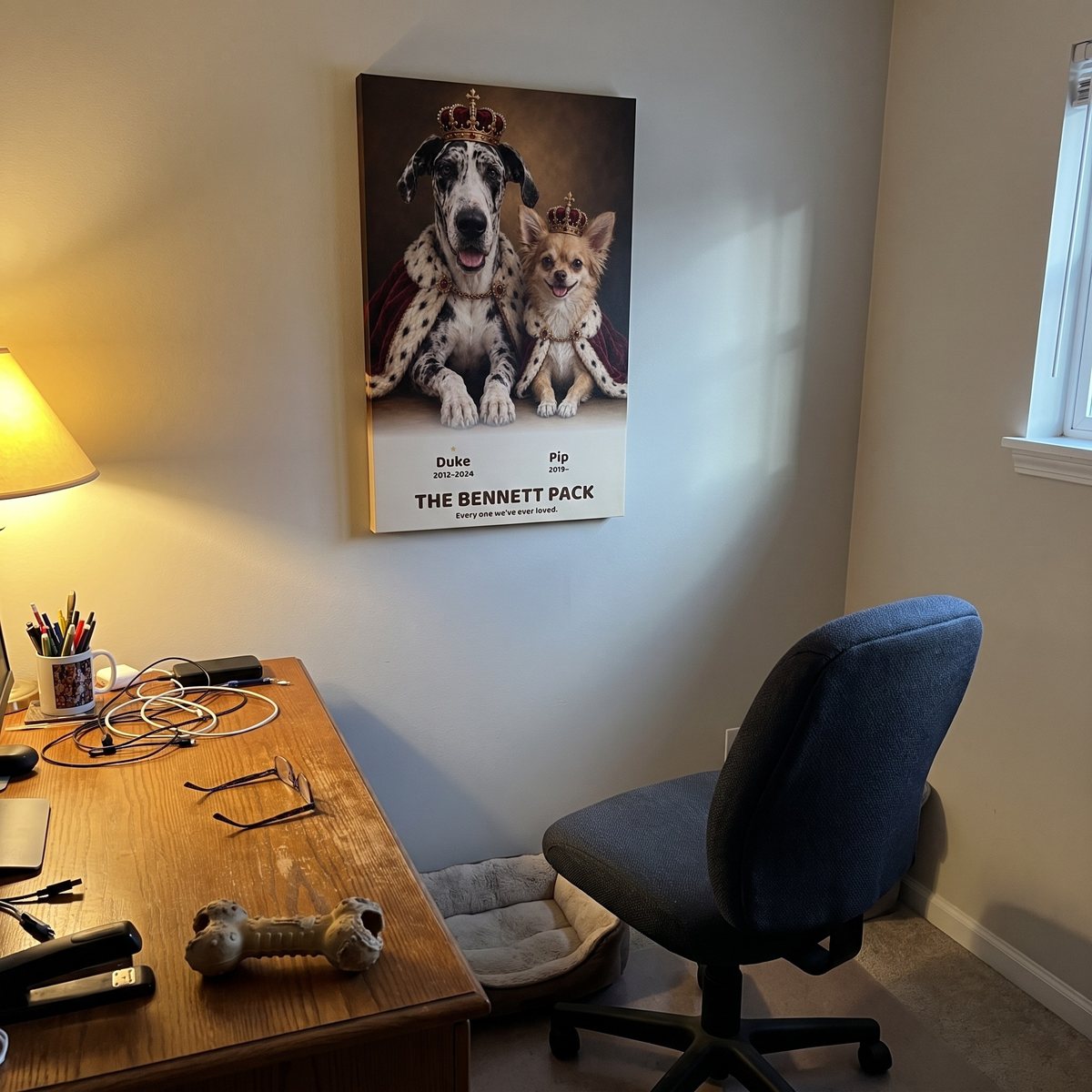 A royal-look portrait of a Great Dane and a Chihuahua hanging above a desk